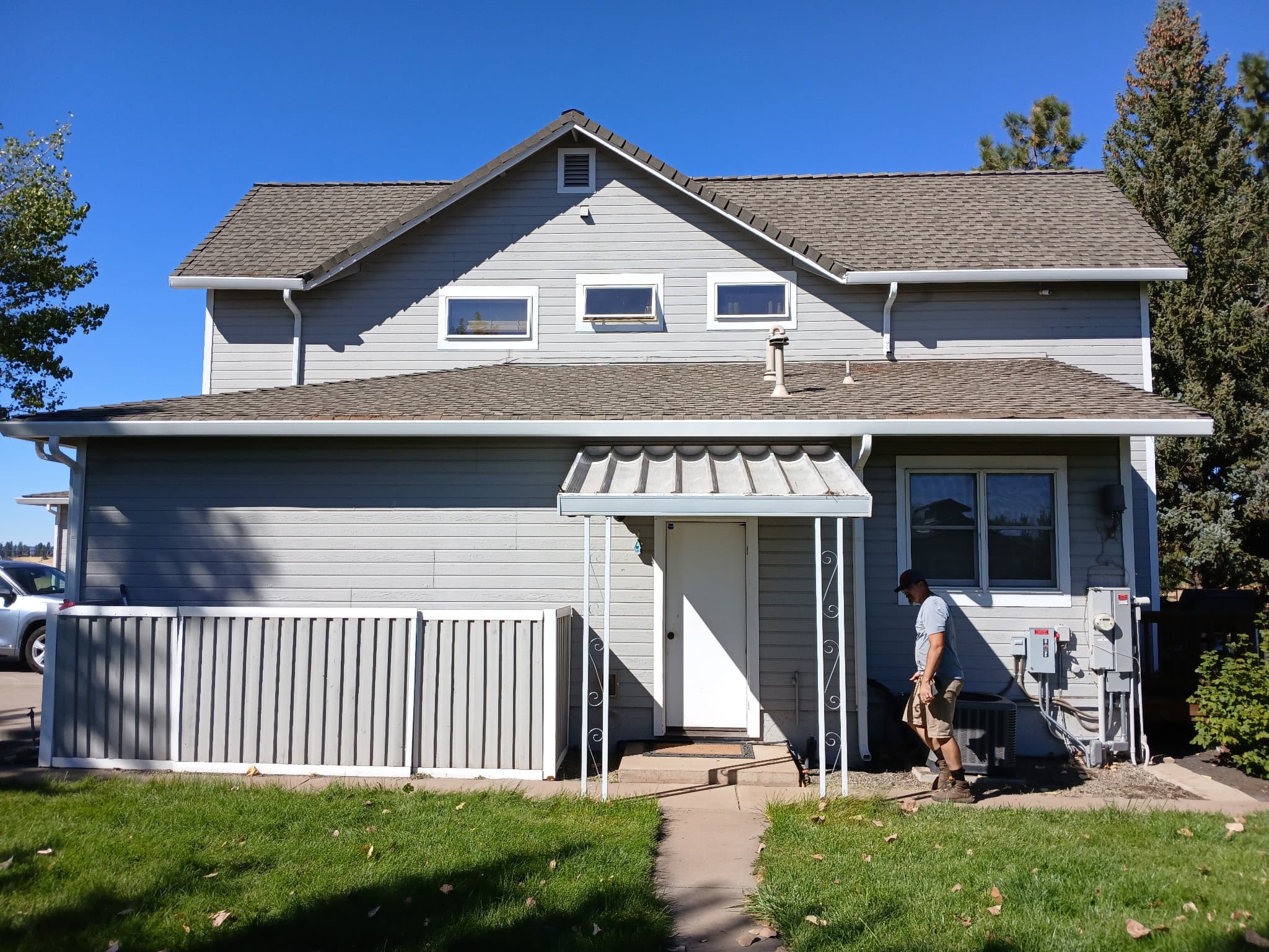 Two-story slate-gray home with new seamless gutters and trim in Redding